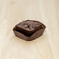 Chocolate candy in a wrapper on a light wooden surface